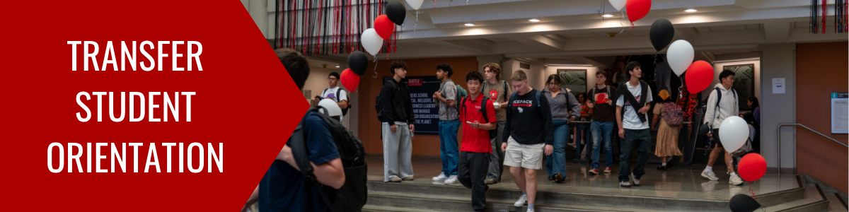 Students walking down stairs at orientation event with red, white, and black balloons