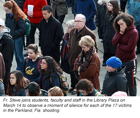 Father Steve joins students, faculty, and staff in the Library Plaza on March 14 to observe a moment of silence for each of the 17 victims in the Parkland, FL shooting