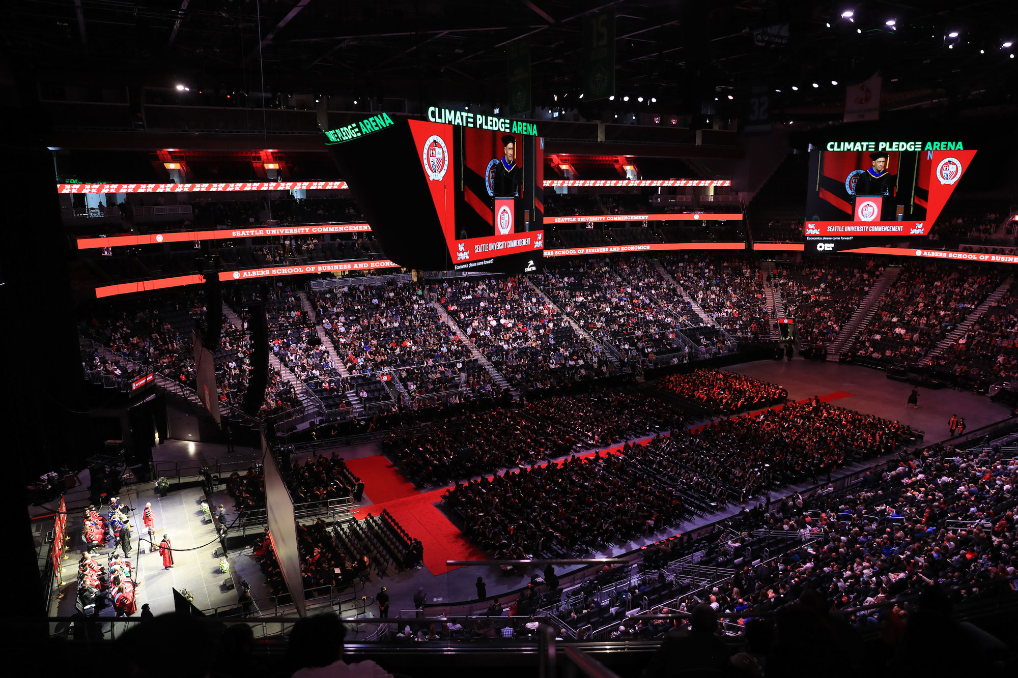 Zoomed out view of the arena as attendees listen to commencement speaker Fr. Reese