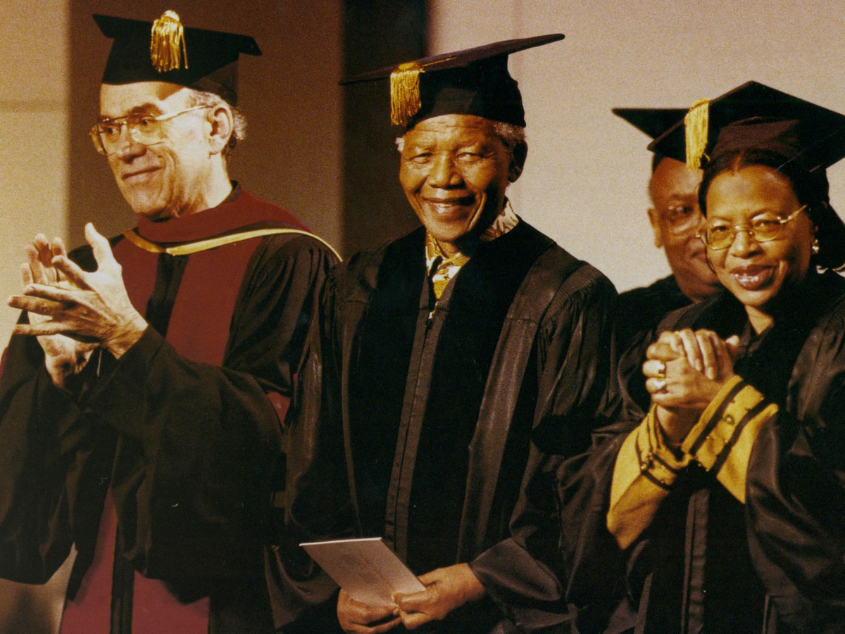 Fr. Sundborg standing alongside Nelson Mandela during a commencement ceremony.