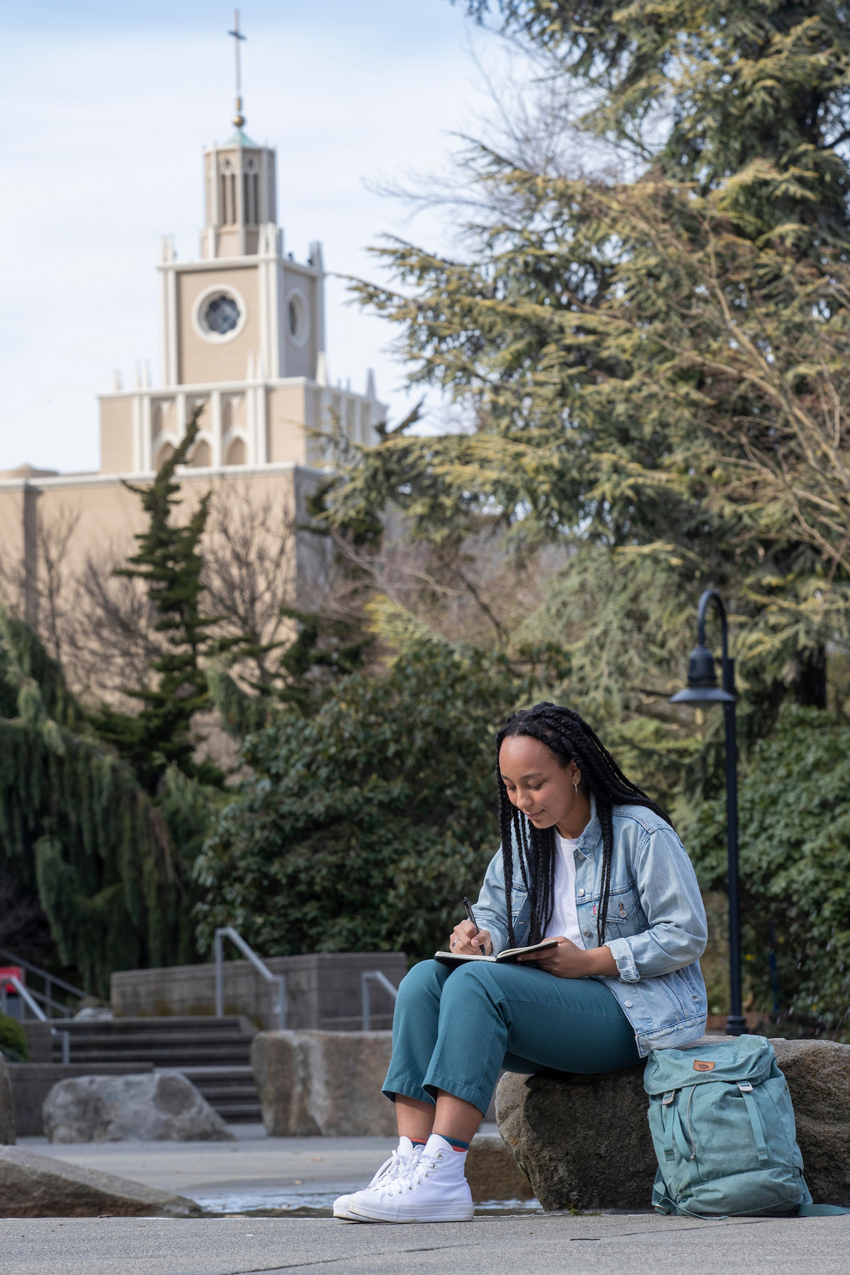 Student studies with book(s) in the Quad