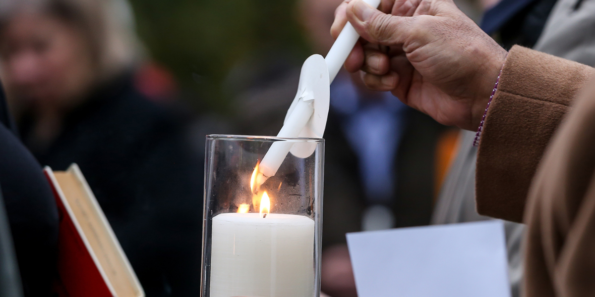 a candle being lit in commemoration of Rev. Dr. Martin Luther King Jr.