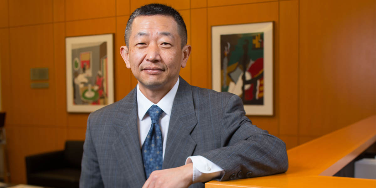 Photo of Robert Chang in his office at the School of Law.