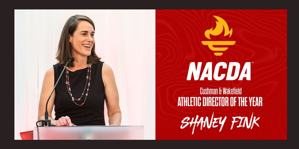 Image of Shaney Fink speaking at podium. Text reads Cushman & Wakfield Athletic Director of the Year Shaney Fink. NACDA logo at top.