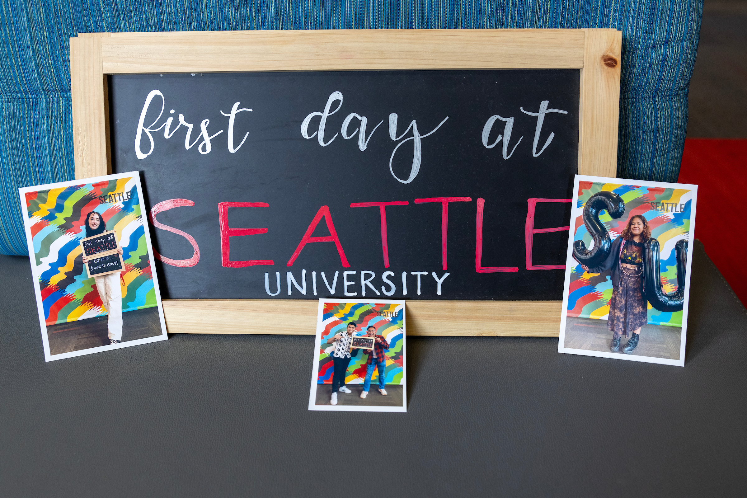 Image of sign with photos of new students on the first day of classes.