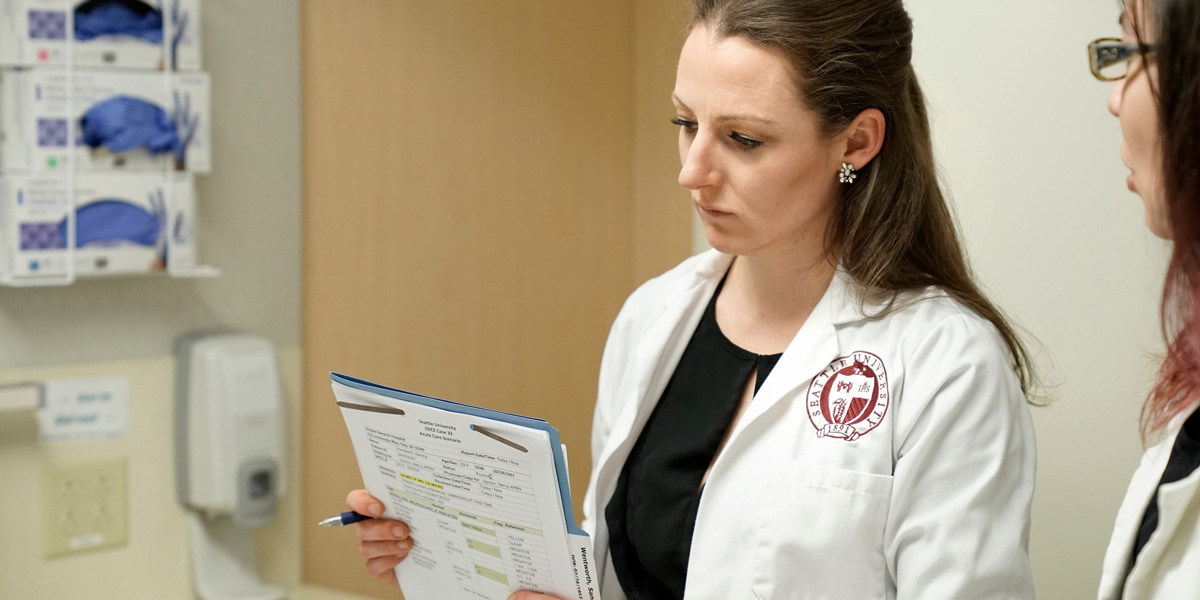 a nursing student reviewing papers in a nursing lab