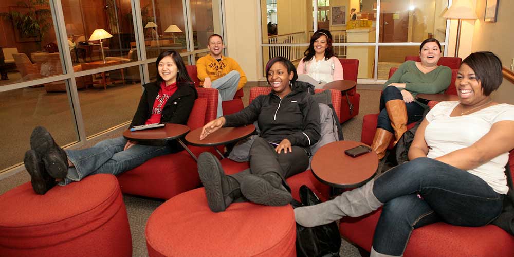   Six students sit in a dorm lounge